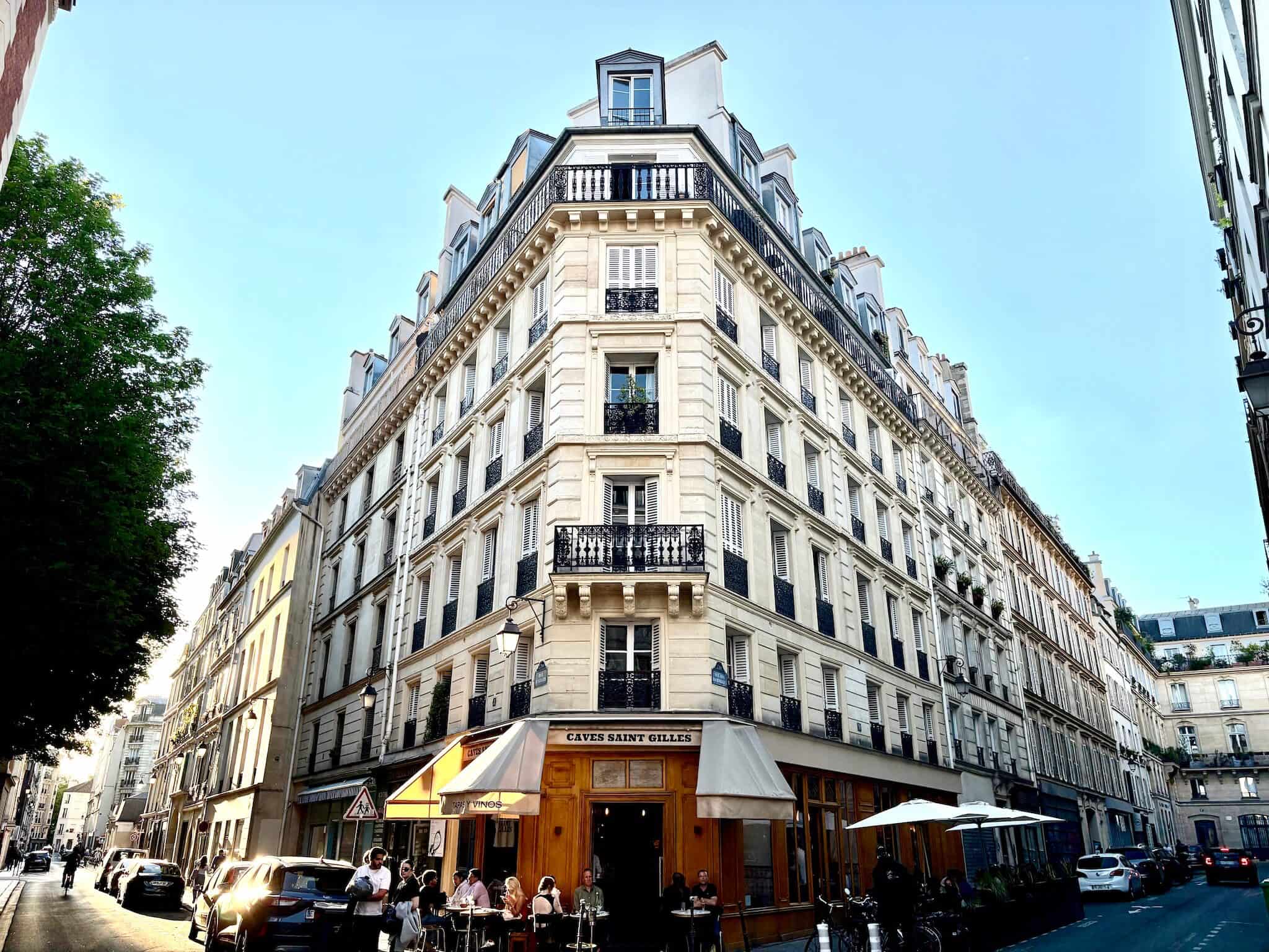 A wide shot of cave st Gilles, at the street level of a haussmanian building on a street corner.