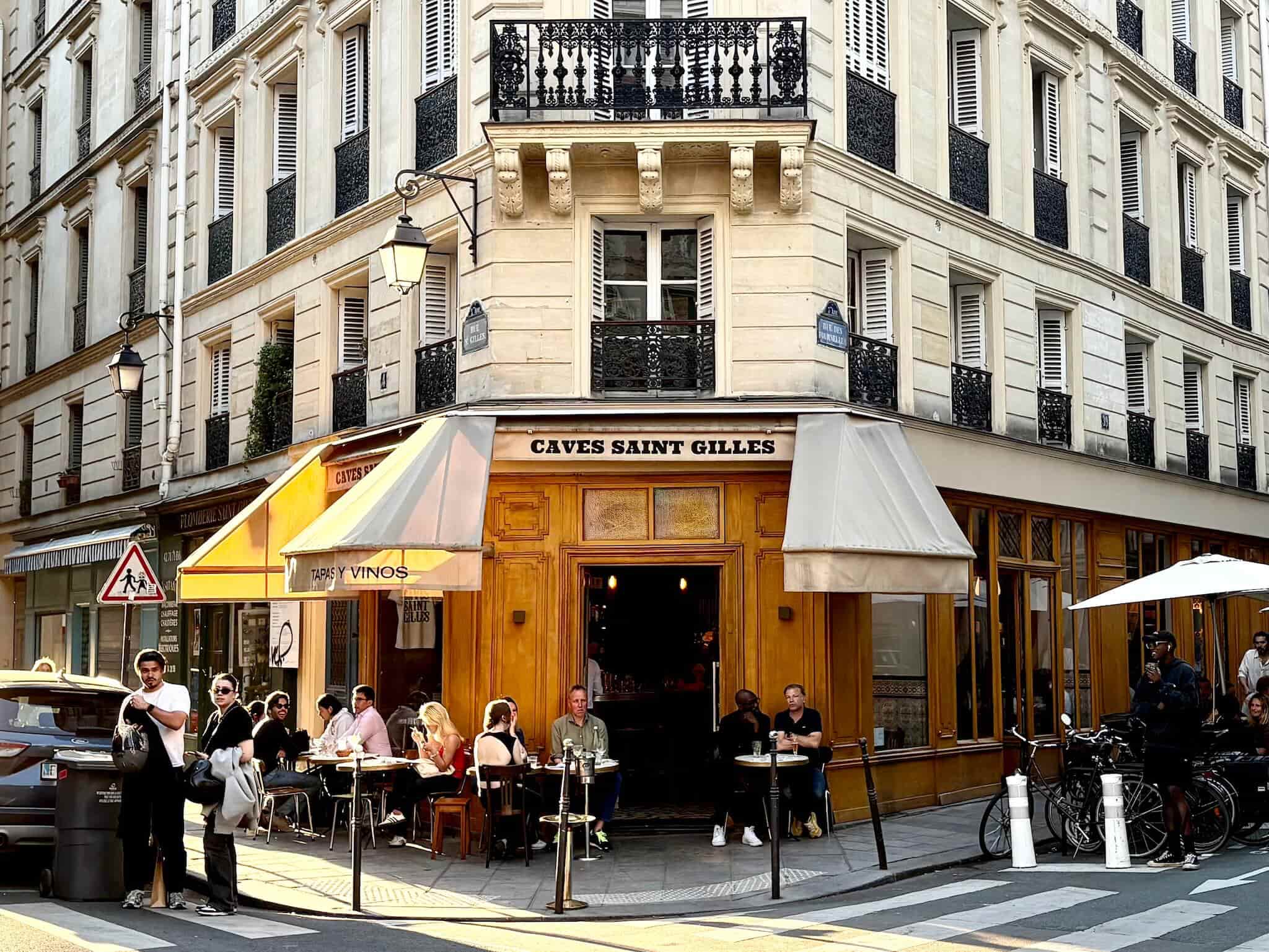 Cave St. Gilles, with a wooden facade and people dining out front.