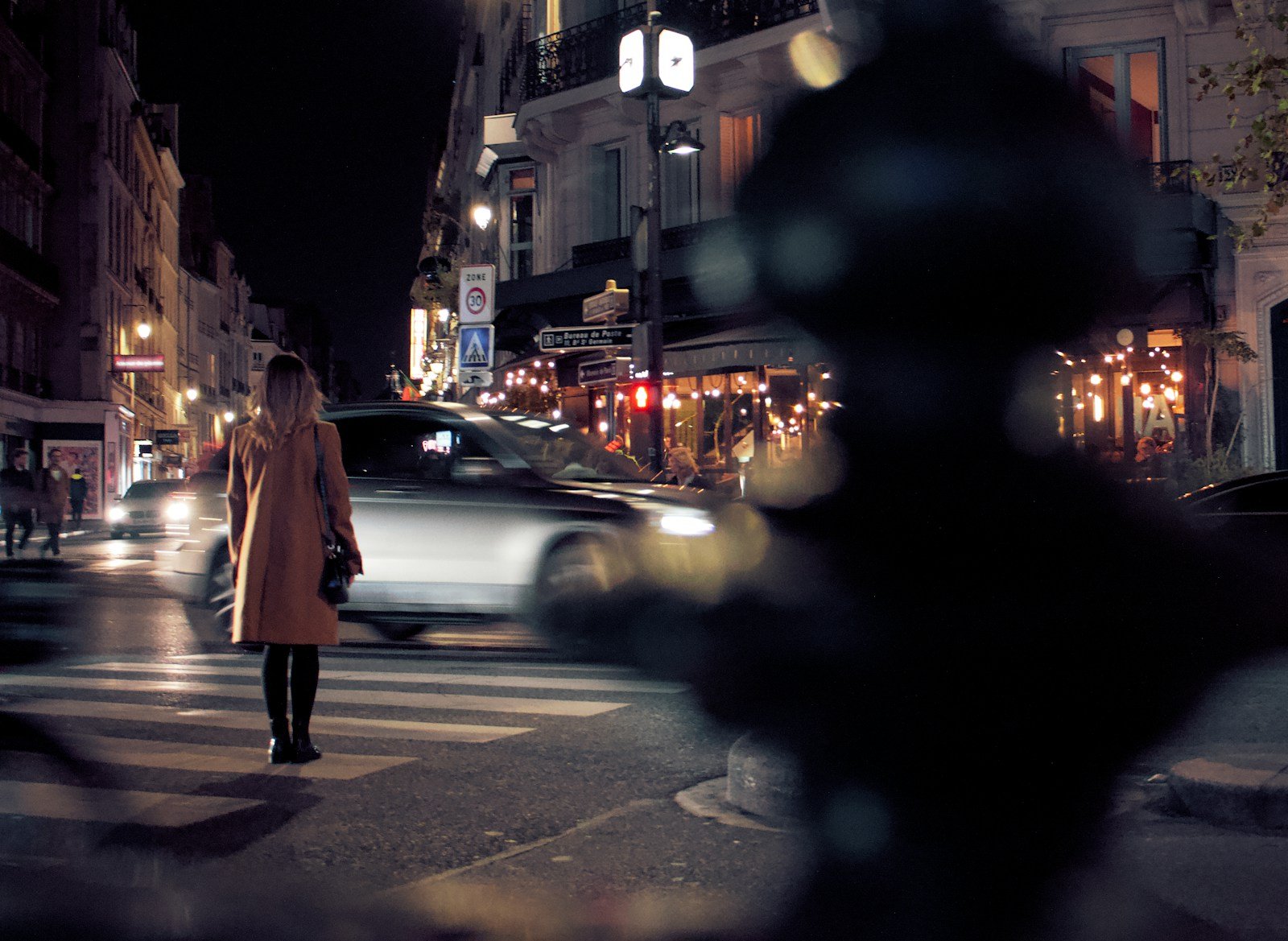selective focus photography of woman beside street.