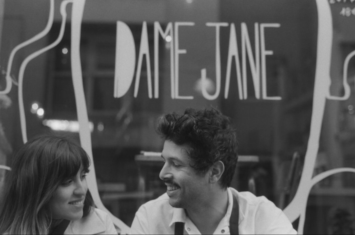 Sam Luevano and boyfriend in front of Dame Jane's cafe in Paris.
