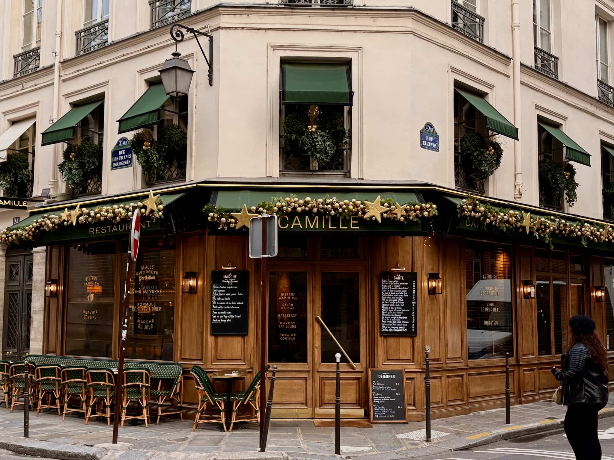 Camille restaurant exterior in the Marais in Paris, decorated for Christmas.