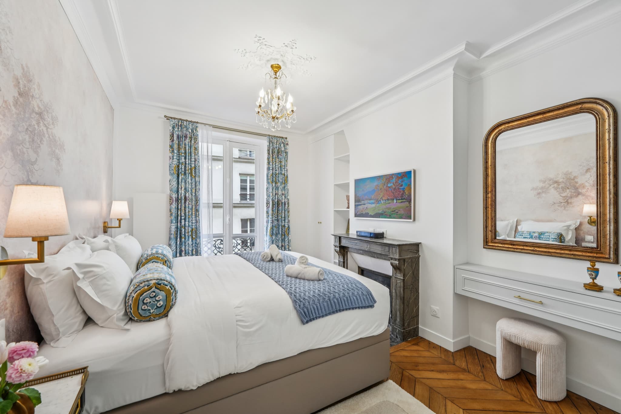 Parisian apartment bedroom with fireplace and curtains